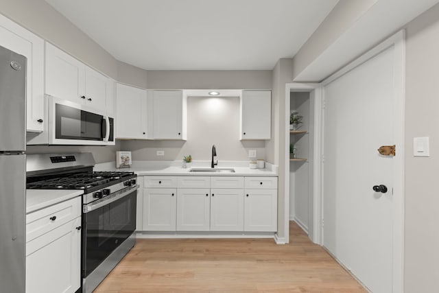 1320B Lore Ln Unit 117, Lombard, IL 60148 - kitchen with appliances with stainless steel finishes, a sink, light wood-style flooring, and light countertops