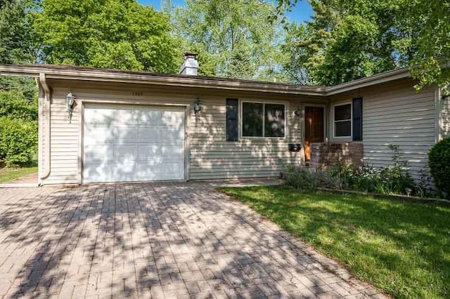1322 Empire Ct, Freeport, IL 61032 - single story home with a garage, a chimney, decorative driveway, and a front yard