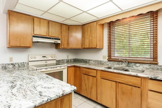 1322 Empire Ct, Freeport, IL 61032 - kitchen with under cabinet range hood, white range with electric stovetop, a sink, light tile patterned floors, and light stone counters