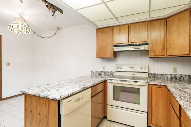 1322 Empire Ct, Freeport, IL 61032 - kitchen with white appliances, under cabinet range hood, light tile patterned floors, a peninsula, and brown cabinetry
