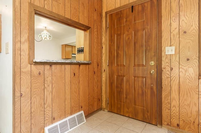 1322 Empire Ct, Freeport, IL 61032 - foyer entrance featuring wood walls, a chandelier, and light tile patterned floors