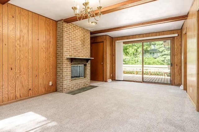 1322 Empire Ct, Freeport, IL 61032 - unfurnished living room featuring wooden walls, beamed ceiling, a brick fireplace, carpet floors, and a chandelier