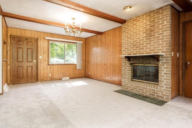 1322 Empire Ct, Freeport, IL 61032 - unfurnished living room with beam ceiling, wood walls, carpet floors, a chandelier, and a fireplace