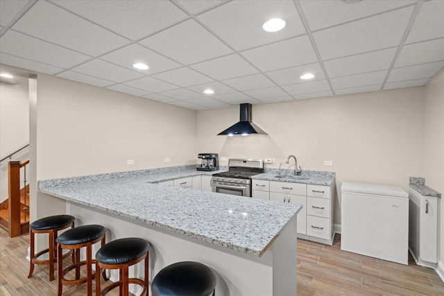 15629 W 139th St, Homer Glen, IL 60491 - kitchen featuring stainless steel gas stove, wall chimney range hood, light wood finished floors, white cabinets, and recessed lighting