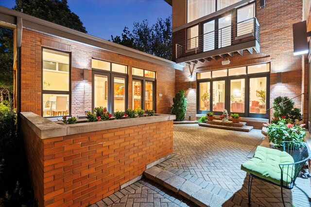 15629 W 139th St, Homer Glen, IL 60491 - patio at twilight with a balcony and french doors