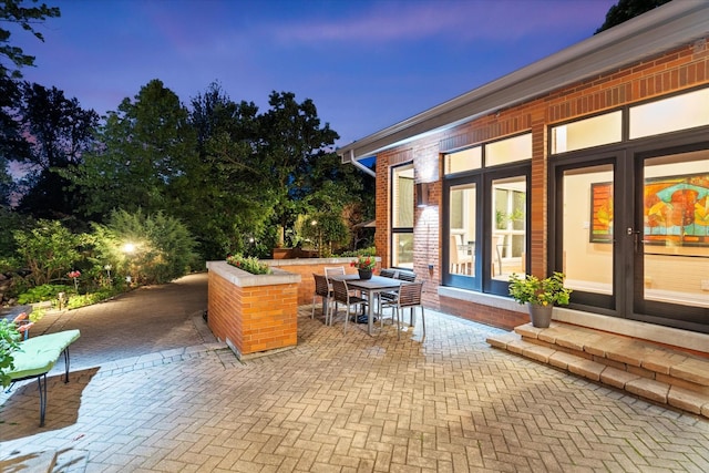 15629 W 139th St, Homer Glen, IL 60491 - patio terrace at dusk with a patio, outdoor dining area, and french doors