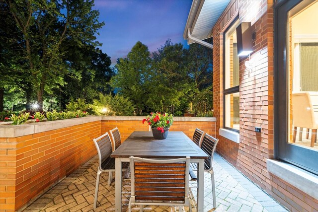 15629 W 139th St, Homer Glen, IL 60491 - patio terrace at dusk featuring a patio and outdoor dining area