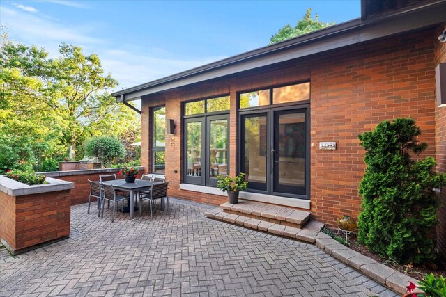 15629 W 139th St, Homer Glen, IL 60491 - doorway to property featuring a patio area, brick siding, and outdoor dining area