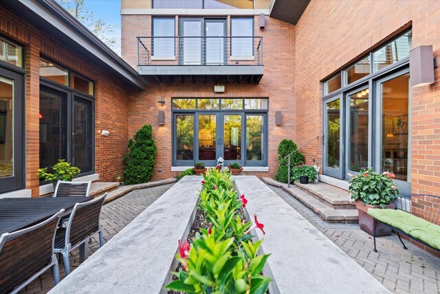 15629 W 139th St, Homer Glen, IL 60491 - doorway to property with french doors, brick siding, a balcony, and outdoor dining area