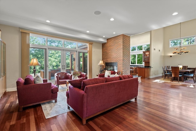 15629 W 139th St, Homer Glen, IL 60491 - living area featuring wood finished floors, a chandelier, recessed lighting, baseboards, and a brick fireplace