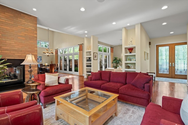 15629 W 139th St, Homer Glen, IL 60491 - living area featuring french doors, light wood-type flooring, a chandelier, recessed lighting, and high vaulted ceiling