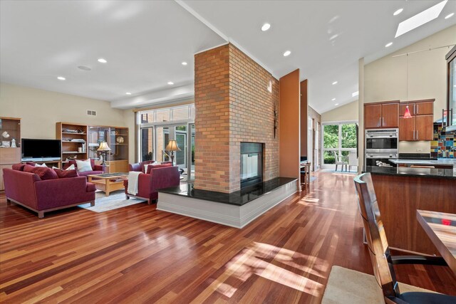 15629 W 139th St, Homer Glen, IL 60491 - living area with wood finished floors, a brick fireplace, recessed lighting, a skylight, and high vaulted ceiling