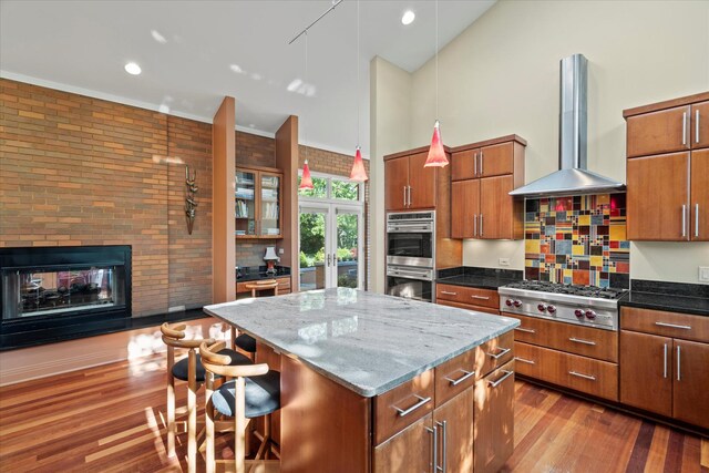 15629 W 139th St, Homer Glen, IL 60491 - kitchen featuring island exhaust hood, high vaulted ceiling, stainless steel appliances, a breakfast bar area, and a center island