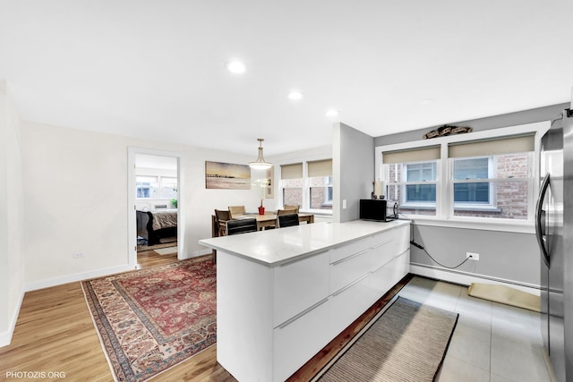8758 W Berwyn Ave Unit 2N, Chicago, IL 60656 - kitchen with a peninsula, plenty of natural light, baseboards, light countertops, and recessed lighting