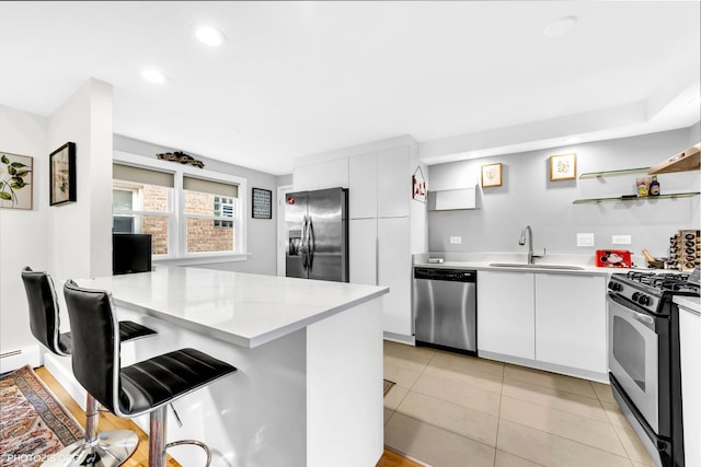 8758 W Berwyn Ave Unit 2N, Chicago, IL 60656 - kitchen with stainless steel appliances, a sink, a peninsula, light countertops, and recessed lighting
