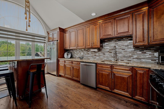 8771 Waterfront Dr Unit 3A, Palos Hills, IL 60465 - kitchen with appliances with stainless steel finishes, a sink, lofted ceiling, backsplash, and light stone counters