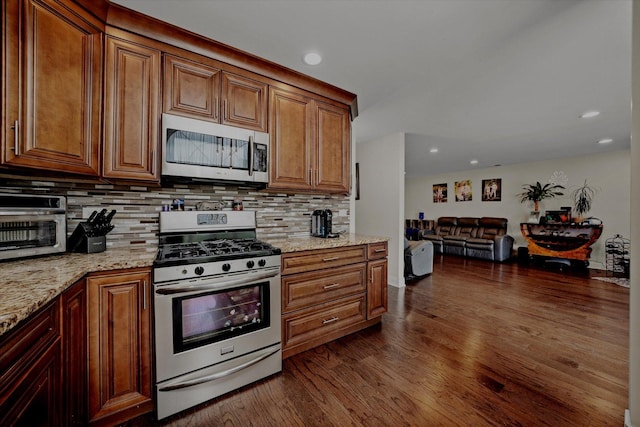 8771 Waterfront Dr Unit 3A, Palos Hills, IL 60465 - kitchen featuring stainless steel appliances, backsplash, dark wood-style flooring, light stone counters, and recessed lighting