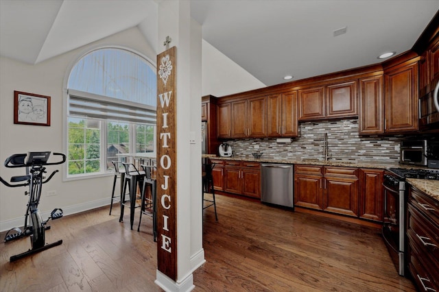 8771 Waterfront Dr Unit 3A, Palos Hills, IL 60465 - kitchen with appliances with stainless steel finishes, a sink, vaulted ceiling, dark wood-style floors, and light stone counters