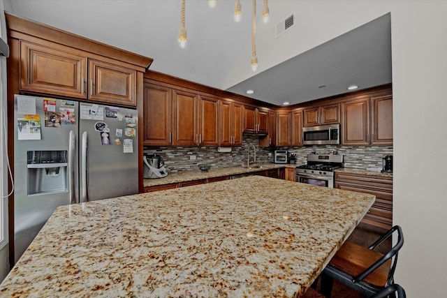 8771 Waterfront Dr Unit 3A, Palos Hills, IL 60465 - kitchen featuring stainless steel appliances, light stone countertops, a center island, backsplash, and recessed lighting