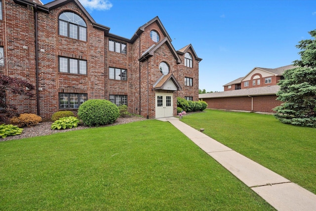 8771 Waterfront Dr Unit 3A, Palos Hills, IL 60465 - view of front of home featuring brick siding and a front lawn