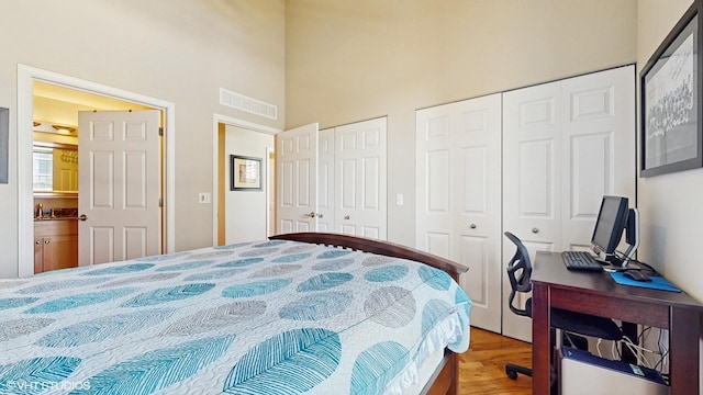 2025 S Indiana Ave Unit 503, Chicago, IL 60616 - bedroom featuring multiple closets, a high ceiling, wood finished floors, and an office area