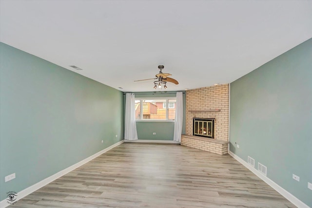 16560 Currant Ave, Tinley Park, IL 60487 - unfurnished living room with ceiling fan, wood finished floors, baseboards, and a fireplace