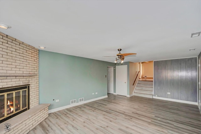 16560 Currant Ave, Tinley Park, IL 60487 - unfurnished living room featuring a fireplace, wood finished floors, baseboards, stairway, and ceiling fan