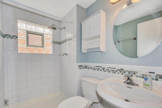 16560 Currant Ave, Tinley Park, IL 60487 - bathroom with a sink, a tile shower, toilet, tile walls, and a wainscoted wall
