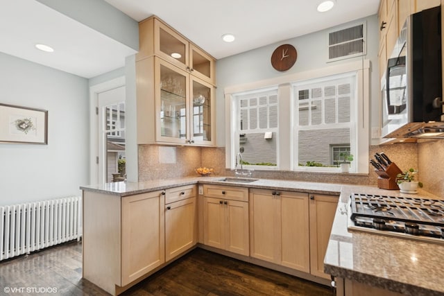 310 Fairview Ave, Winnetka, IL 60093 - kitchen featuring radiator, stainless steel appliances, a sink, light brown cabinetry, and a peninsula