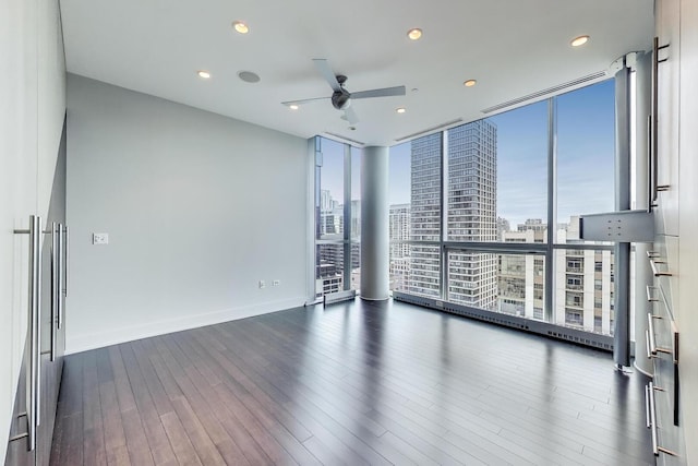 110 W Superior St Unit 1703, Chicago, IL 60654 - unfurnished room with a wall of windows, plenty of natural light, a city view, a ceiling fan, and dark wood finished floors