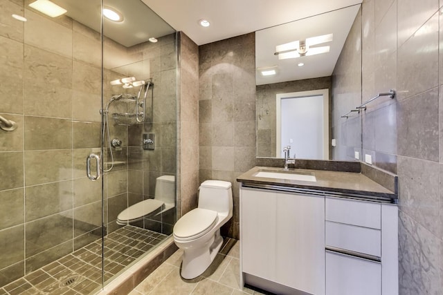 110 W Superior St Unit 1703, Chicago, IL 60654 - full bathroom with tile walls, toilet, vanity, a stall shower, and tile patterned floors