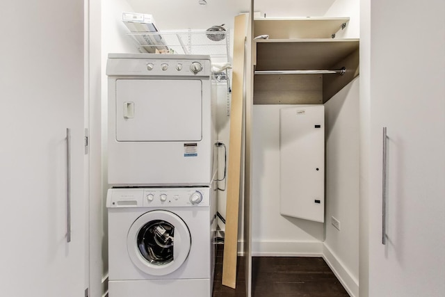 110 W Superior St Unit 1703, Chicago, IL 60654 - washroom featuring stacked washer / dryer, dark wood-style floors, and baseboards
