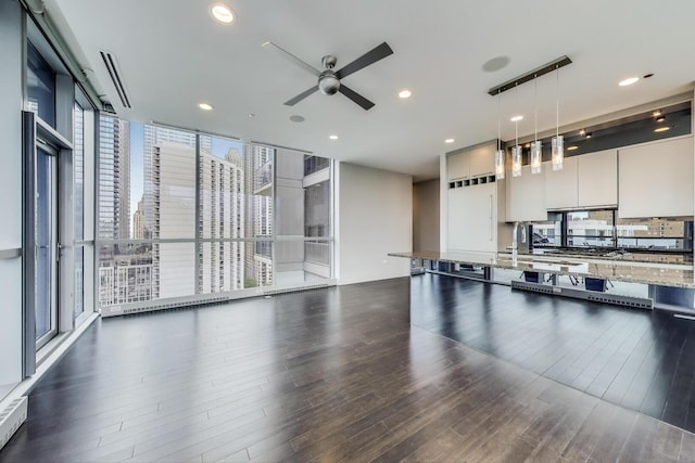 110 W Superior St Unit 1703, Chicago, IL 60654 - kitchen with dark wood finished floors, ceiling fan, light stone countertops, decorative light fixtures, and expansive windows