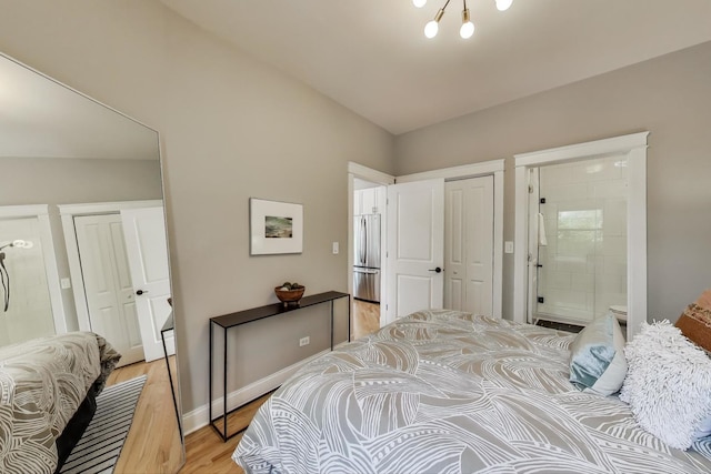 3706 W Wrightwood Ave Unit 3A, Chicago, IL 60647 - bedroom with freestanding refrigerator, light wood-type flooring, a closet, ensuite bath, and lofted ceiling
