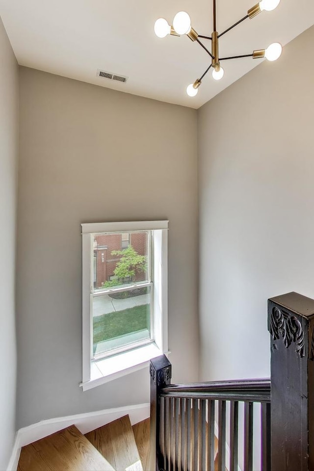3706 W Wrightwood Ave Unit 3A, Chicago, IL 60647 - stairway with baseboards, wood finished floors, and a chandelier