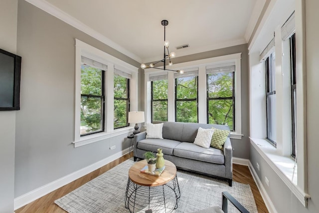 3706 W Wrightwood Ave Unit 3A, Chicago, IL 60647 - living area featuring plenty of natural light, a chandelier, baseboards, and ornamental molding