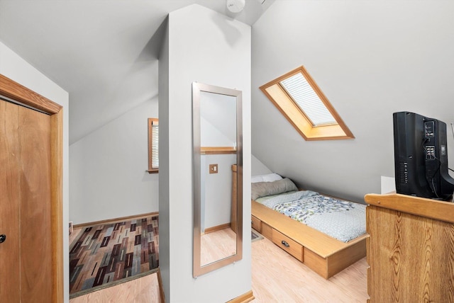 5106 W 64th St, Chicago, IL 60638 - bedroom featuring a skylight, lofted ceiling, wood finished floors, and baseboards