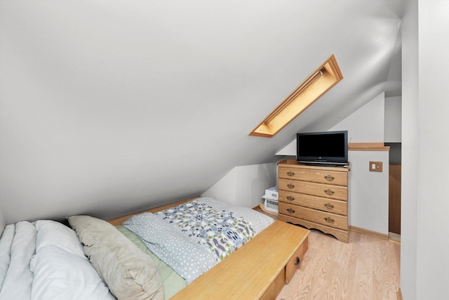 5106 W 64th St, Chicago, IL 60638 - bedroom featuring light wood-type flooring, a skylight, lofted ceiling, and baseboards