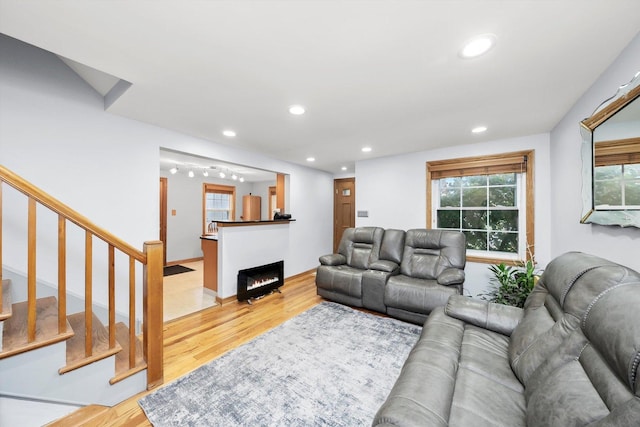 5106 W 64th St, Chicago, IL 60638 - living area featuring light wood-style floors, recessed lighting, stairs, and a warm lit fireplace