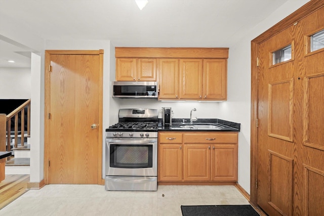 5106 W 64th St, Chicago, IL 60638 - kitchen featuring stainless steel appliances, a sink, dark countertops, and baseboards