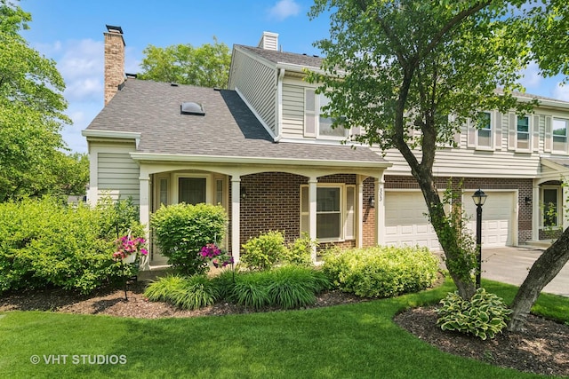 303 College Xing, Rolling Meadows, IL 60008 - view of front of house with a garage, brick siding, a front yard, a shingled roof, and driveway
