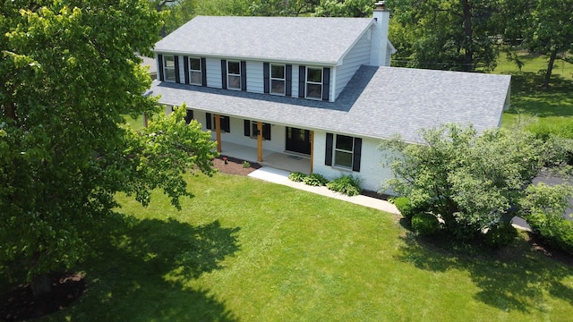 420 N E Gateway Dr, Tower Lakes, IL 60010 - view of front of property featuring a chimney, a shingled roof, a porch, and a front lawn
