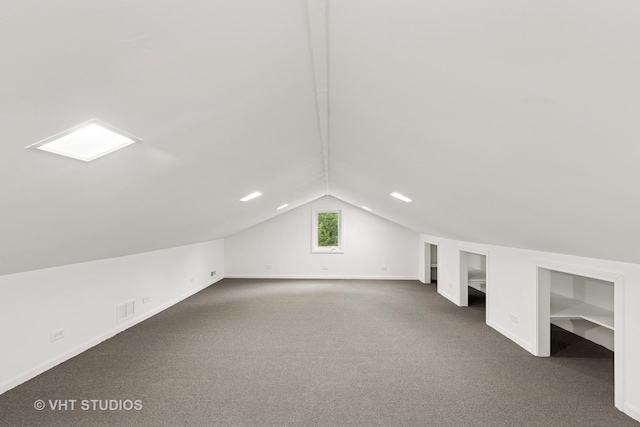 420 N E Gateway Dr, Tower Lakes, IL 60010 - additional living space featuring baseboards, vaulted ceiling, and dark colored carpet