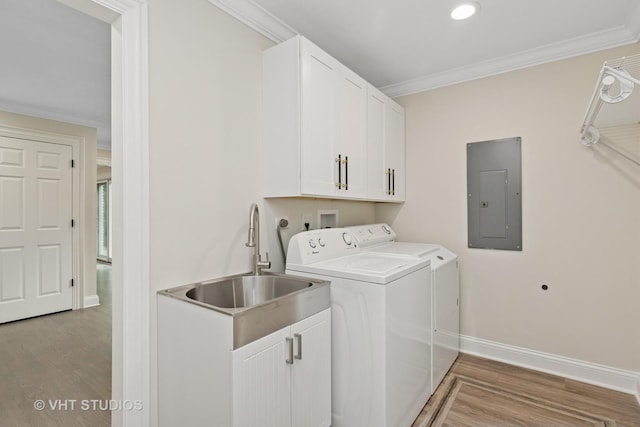 420 N E Gateway Dr, Tower Lakes, IL 60010 - laundry room featuring electric panel, washing machine and dryer, crown molding, cabinet space, and light wood-style flooring