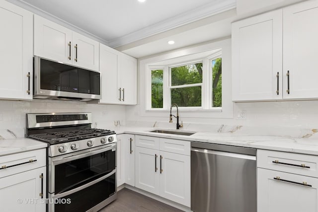 420 N E Gateway Dr, Tower Lakes, IL 60010 - kitchen with stainless steel appliances, a sink, white cabinets, backsplash, and recessed lighting