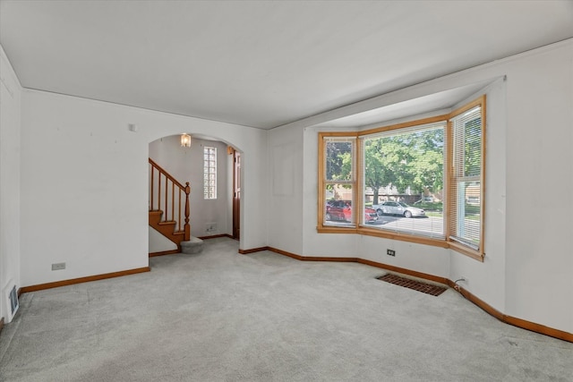 3601 S 57th Ct, Cicero, IL 60804 - carpeted spare room featuring arched walkways, baseboards, and stairway
