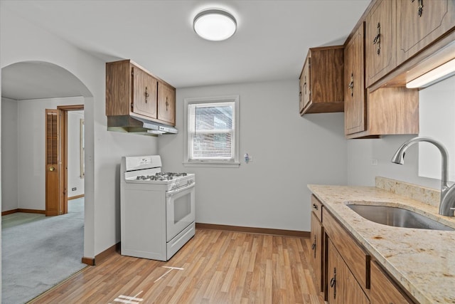 3601 S 57th Ct, Cicero, IL 60804 - kitchen featuring gas range gas stove, a sink, under cabinet range hood, and baseboards