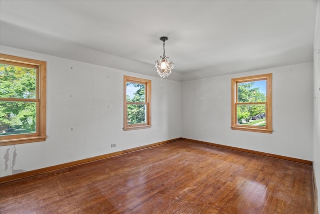 3601 S 57th Ct, Cicero, IL 60804 - unfurnished room with healthy amount of natural light, hardwood / wood-style flooring, and a chandelier