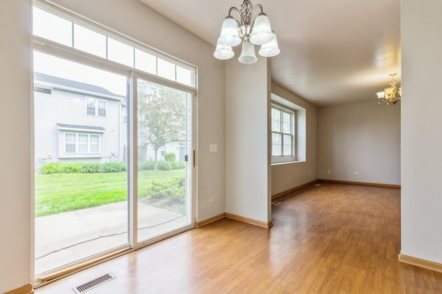 3856 Pathfinder Ln, Joliet, IL 60435 - spare room with a chandelier, wood finished floors, and baseboards