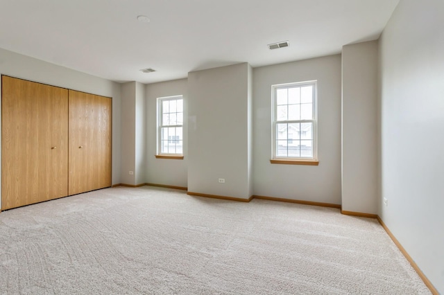 3856 Pathfinder Ln, Joliet, IL 60435 - unfurnished bedroom with light colored carpet, baseboards, and a closet